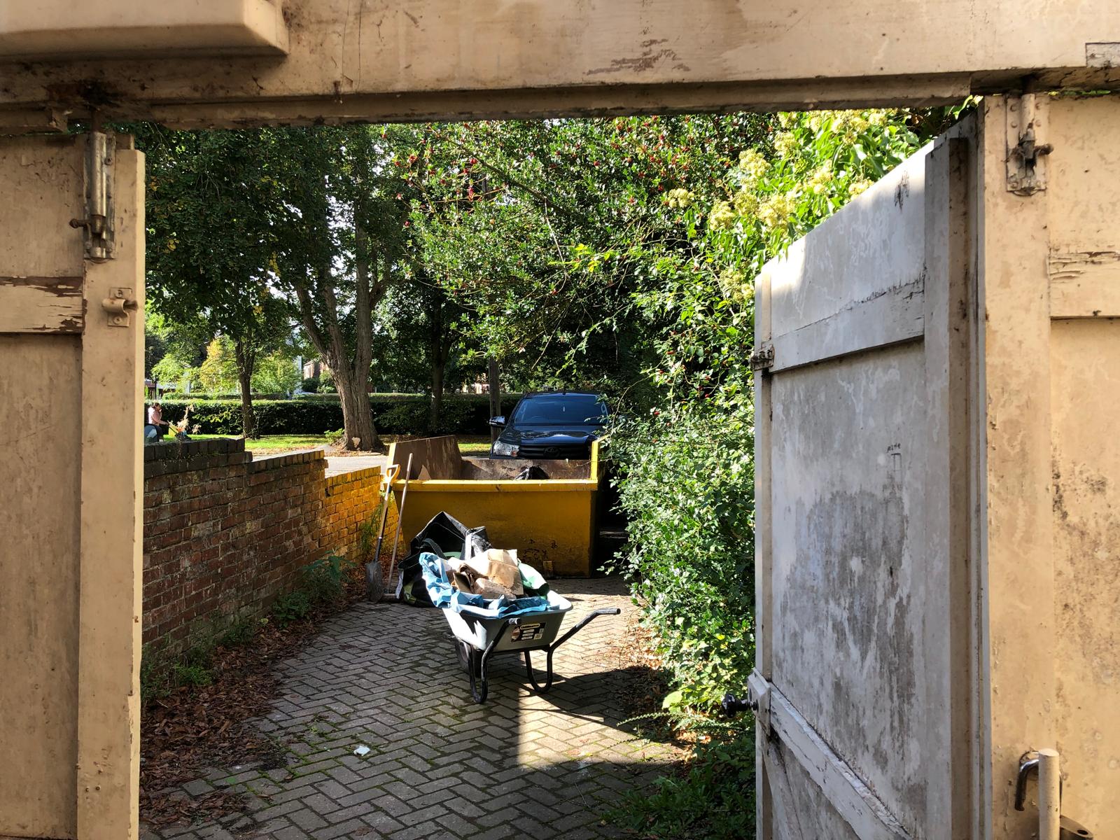 a full wheelbarrow sitting in a yard filled with light
