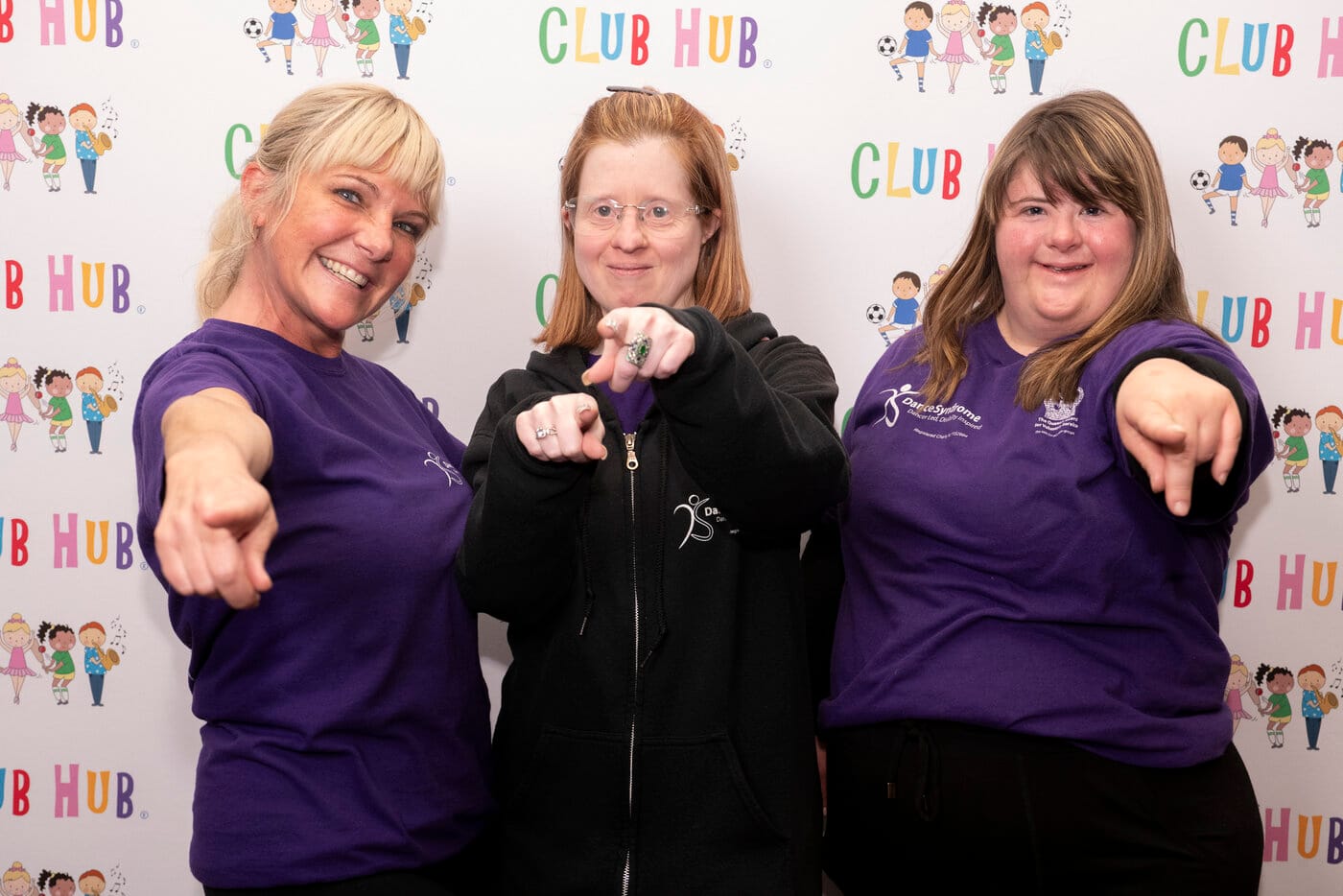 Donna Jen and Lucy pointing to you in front of ClubHubUK banner