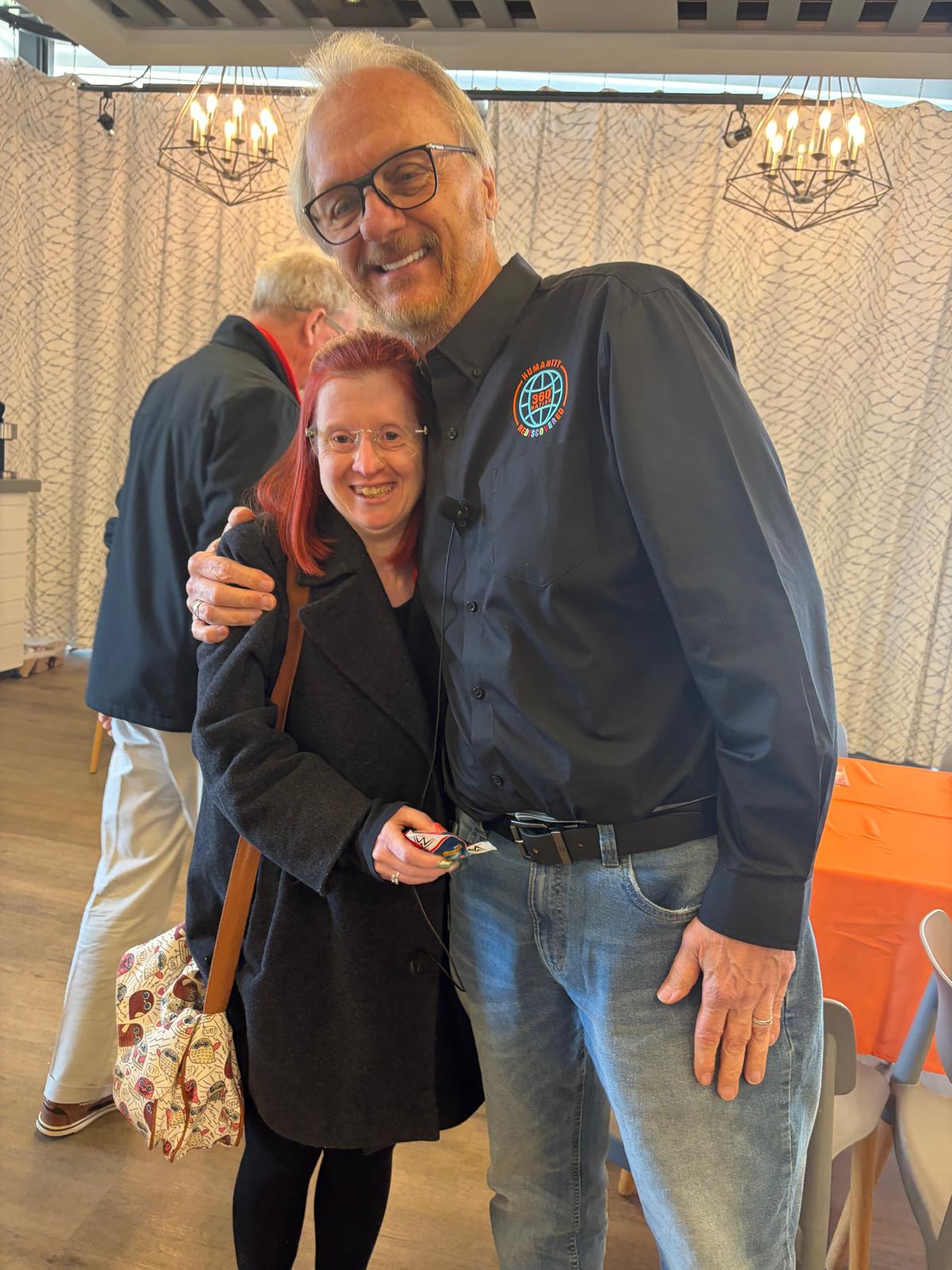 Tall man embracing shorter lady both with huge smiles on faces