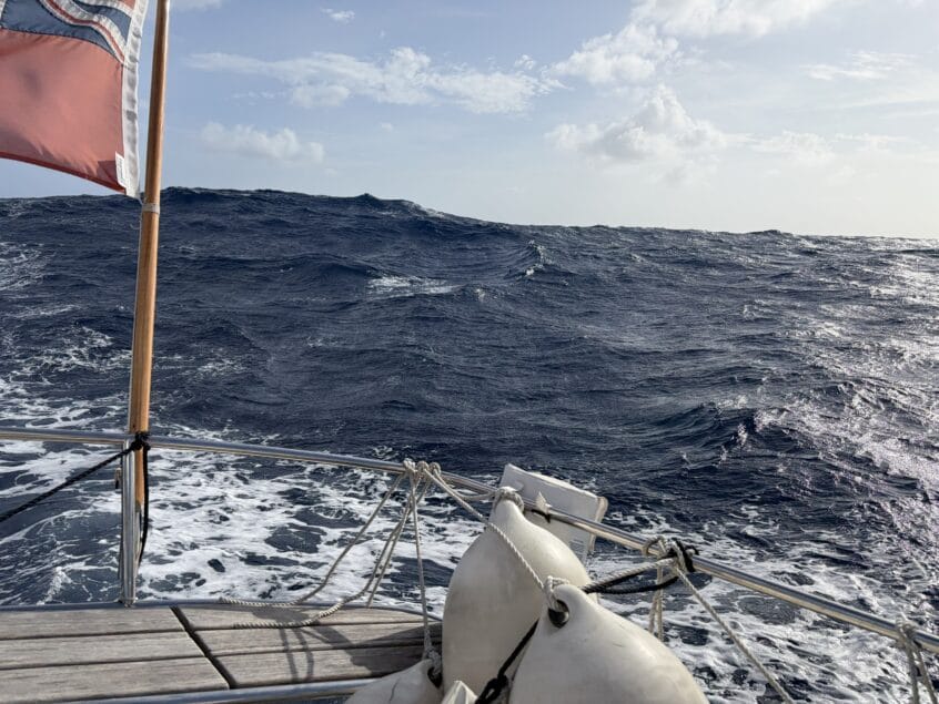 Looking towards the back of a yacht at the rolling waves