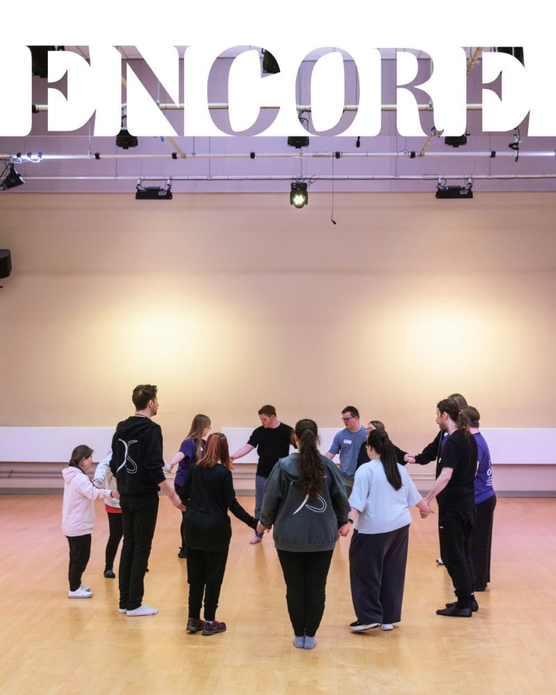 Group of people in circle preparing to dance with words ENCORE at top of image